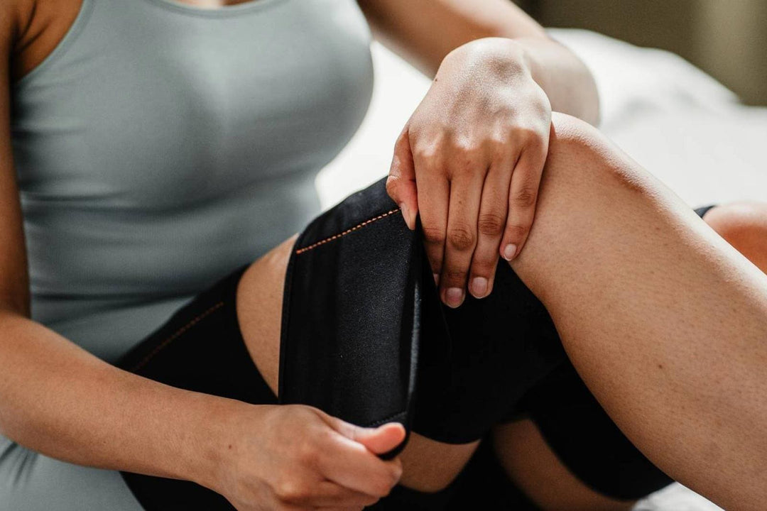 Exercise On Autopilot With BionicGym - BionicGym. A close up of a female leg putting on BioicGym wraps.
